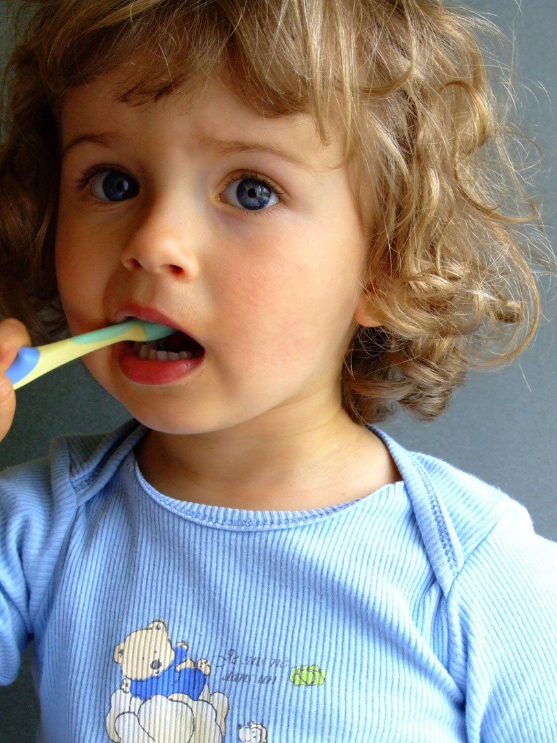 A toddler brushing teeth